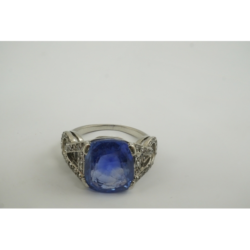 215 - A mid to late 20th century platinum and single stone tapered cushion cut sapphire set dress ring, wi... 