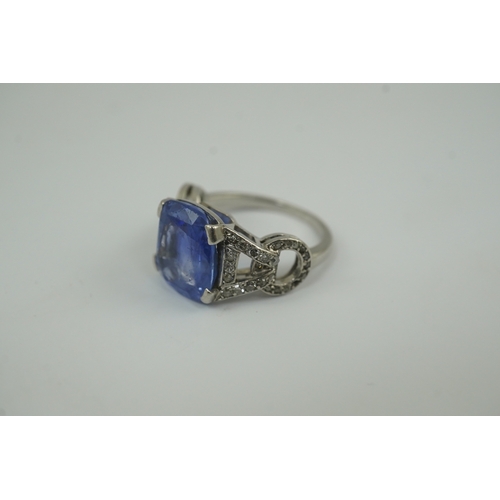 215 - A mid to late 20th century platinum and single stone tapered cushion cut sapphire set dress ring, wi... 