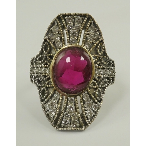 219 - A gold, cabochon ruby and diamond cluster set upfinger ring, in a 'filigree' setting, size N, gross ... 