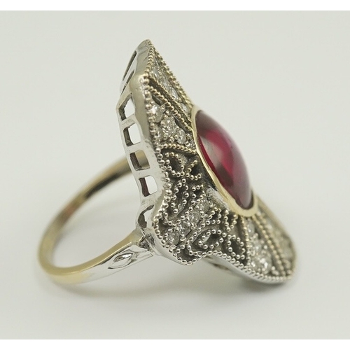 219 - A gold, cabochon ruby and diamond cluster set upfinger ring, in a 'filigree' setting, size N, gross ... 