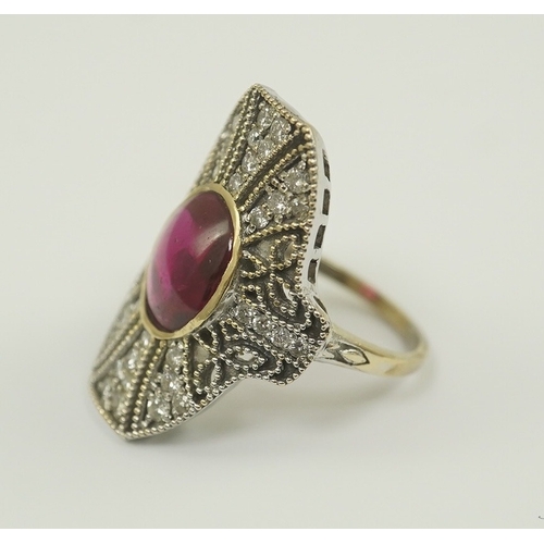 219 - A gold, cabochon ruby and diamond cluster set upfinger ring, in a 'filigree' setting, size N, gross ... 