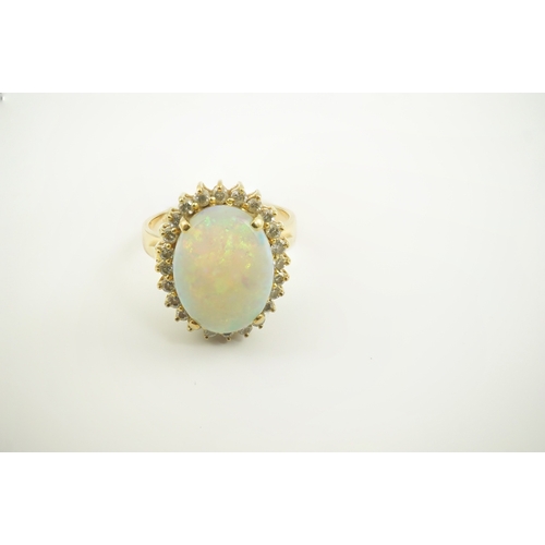 220 - An 18k gold, white opal and diamond set oval cluster ring, size O, gross weight 6.3 grams.