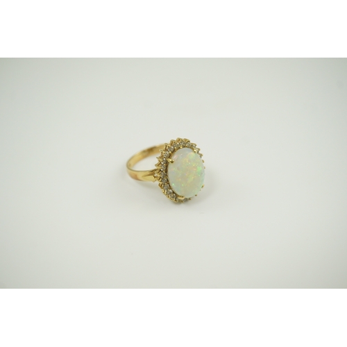 220 - An 18k gold, white opal and diamond set oval cluster ring, size O, gross weight 6.3 grams.