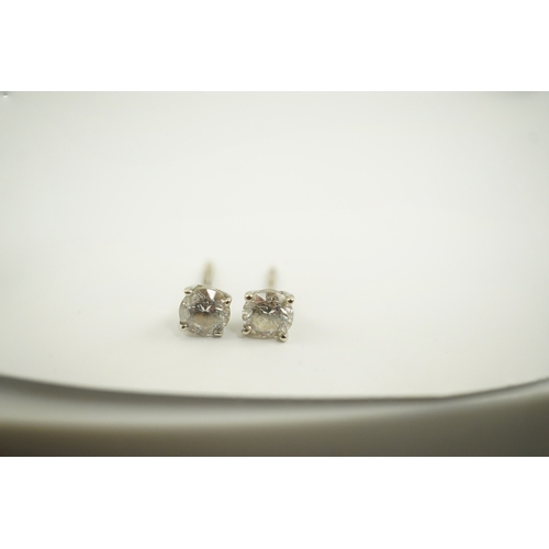 223 - A pair of 14k white gold and solitaire diamond set ear studs, the stones diameter approximately 4.7m... 