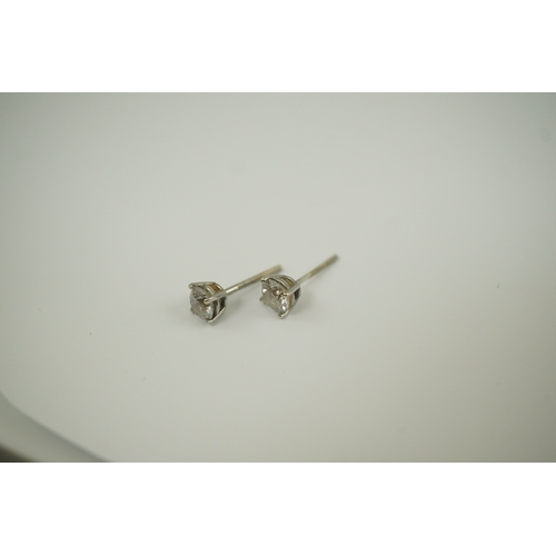 223 - A pair of 14k white gold and solitaire diamond set ear studs, the stones diameter approximately 4.7m... 