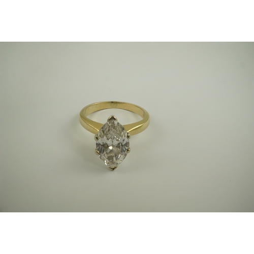 226 - A modern 14k gold and solitaire marquise diamond set ring, the stone weighing approximately 2.75cts,... 