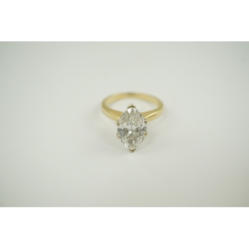 226 - A modern 14k gold and solitaire marquise diamond set ring, the stone weighing approximately 2.75cts,... 