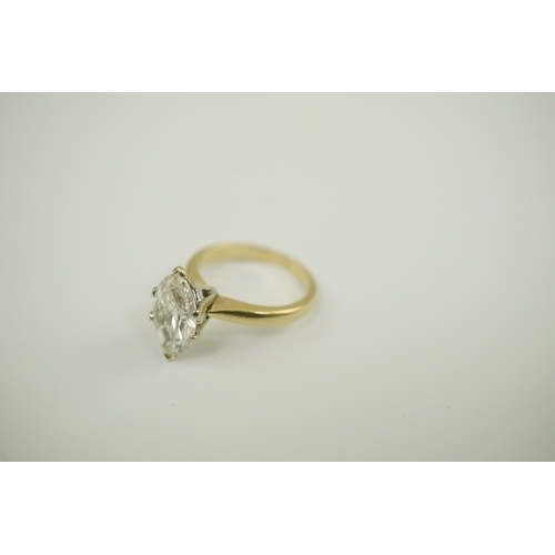 226 - A modern 14k gold and solitaire marquise diamond set ring, the stone weighing approximately 2.75cts,... 