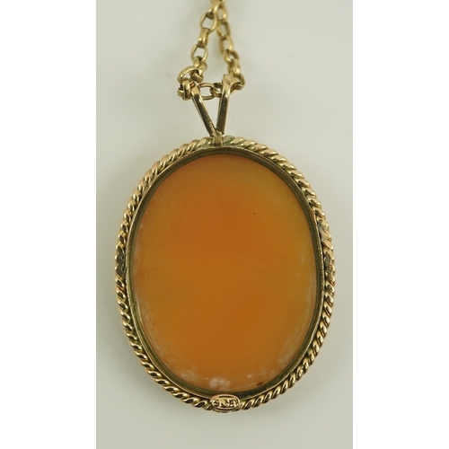 230 - A 9ct gold mounted oval cameo shell pendant, on a 9k gold chain, carved with the bust of a lady to s... 