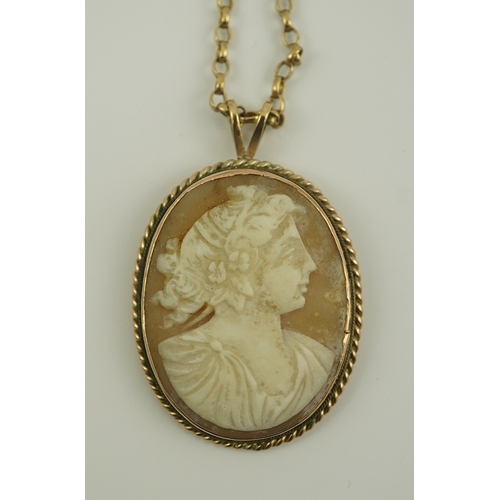 230 - A 9ct gold mounted oval cameo shell pendant, on a 9k gold chain, carved with the bust of a lady to s... 