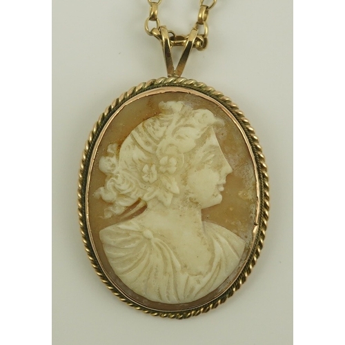 230 - A 9ct gold mounted oval cameo shell pendant, on a 9k gold chain, carved with the bust of a lady to s... 