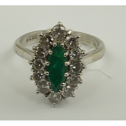 231 - A modern 18ct white gold and single stone marquise cut emerald set ring, bordered with round brillia... 