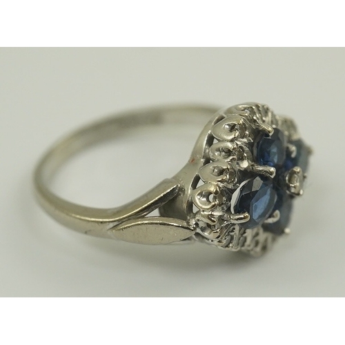 232 - A modern 18ct white gold, sapphire and diamond cluster set ring, of quatrefoil shape, size P/P, gros... 