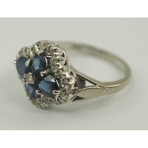 232 - A modern 18ct white gold, sapphire and diamond cluster set ring, of quatrefoil shape, size P/P, gros... 