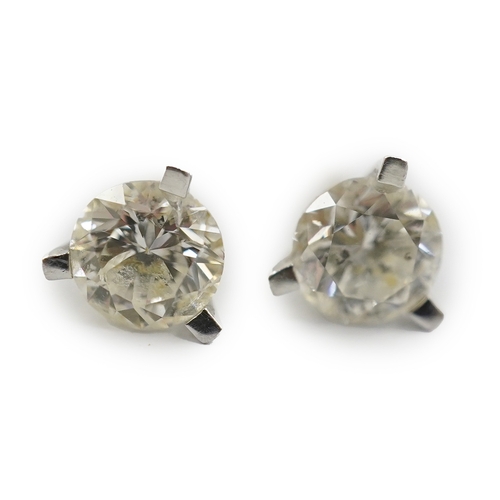 233 - A modern pair of 18ct white gold and solitaire diamond set ear studs, each stone weighing approximat... 