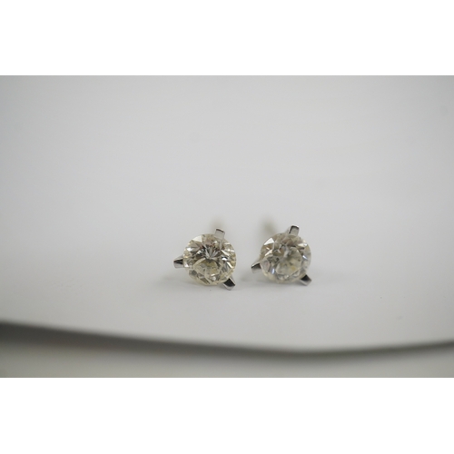 233 - A modern pair of 18ct white gold and solitaire diamond set ear studs, each stone weighing approximat... 