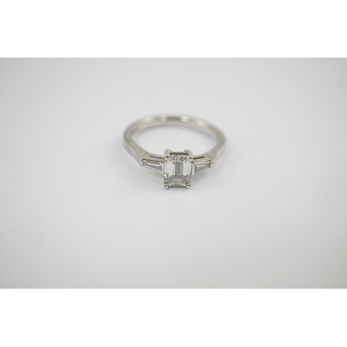 235 - A modern platinum and single stone emerald cut diamond set ring, with two stone tapered baguette cut... 