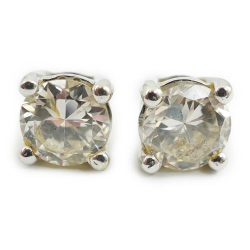 237 - A modern pair of 18k white gold and solitaire diamond set ear studs, the stone diameters approximate... 