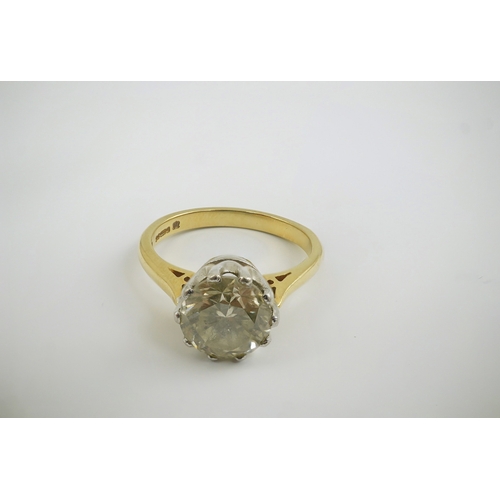 239 - A modern 18ct gold and solitaire round cut diamond set ring, the stone weighing approximately 3.00ct... 