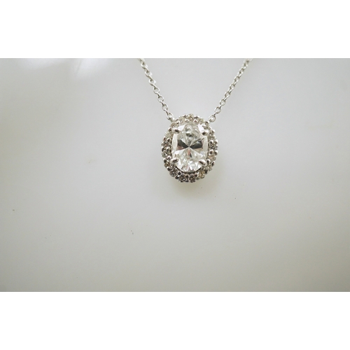 240 - A modern 18k white gold and solitaire oval brilliant cut diamond set pendant necklace, with a copy o... 