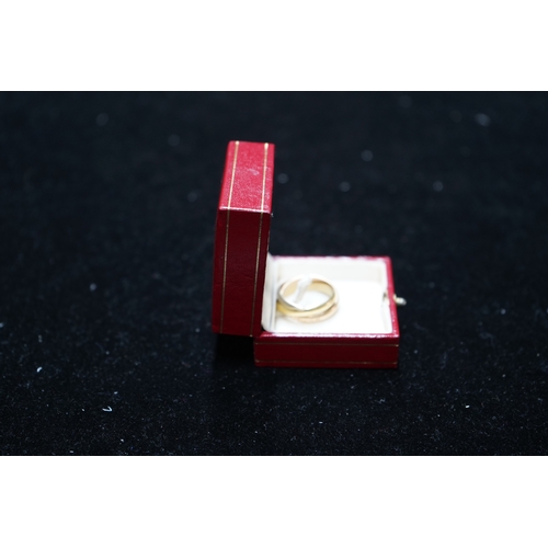 245 - A modern Must De Cartier three colour 18k gold triple band 'Russian' wedding ring, signed and number... 