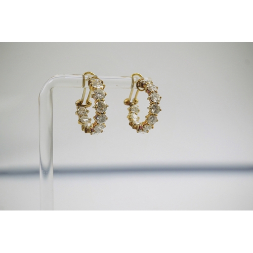 247 - A modern pair of 18ct gold and graduated eleven stone round brilliant cut diamond set hoop earrings,... 