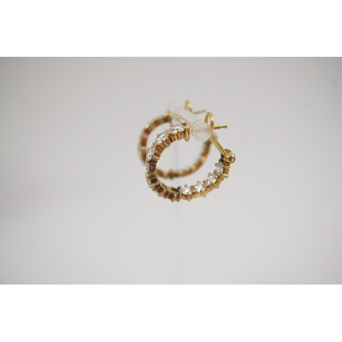 247 - A modern pair of 18ct gold and graduated eleven stone round brilliant cut diamond set hoop earrings,... 