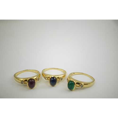 252 - A suite of three modern 18k gold and gem set rings, each set with a cabochon emerald, sapphire or ru... 