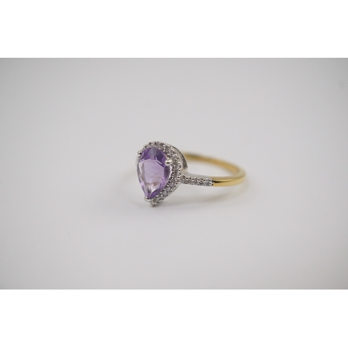 256 - A modern 18ct gold and single stone pear cut amethyst set ring, with diamond chip set border and sho... 