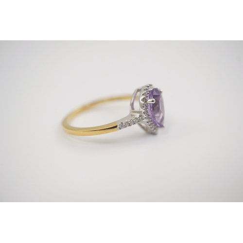 256 - A modern 18ct gold and single stone pear cut amethyst set ring, with diamond chip set border and sho... 