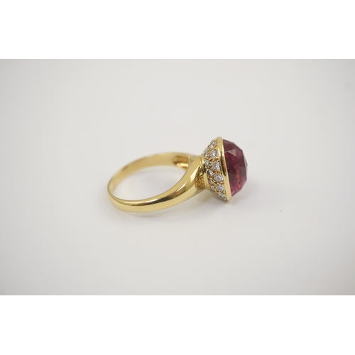 257 - A modern 18k gold and single stone fancy oval cut deep pink tourmaline set dress ring, signed Asprey... 