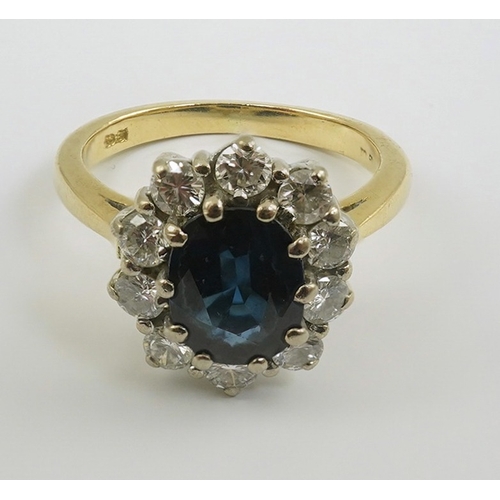 260 - A modern 18ct gold, sapphire and diamond set oval cluster ring, size K/L, gross weight 4.8 grams.... 