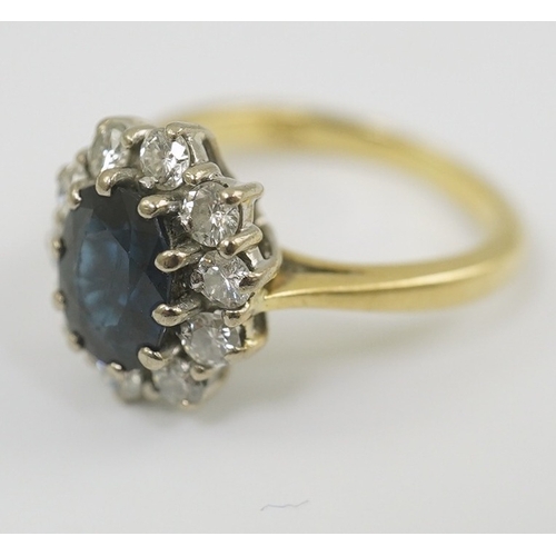 260 - A modern 18ct gold, sapphire and diamond set oval cluster ring, size K/L, gross weight 4.8 grams.... 