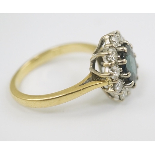 260 - A modern 18ct gold, sapphire and diamond set oval cluster ring, size K/L, gross weight 4.8 grams.... 