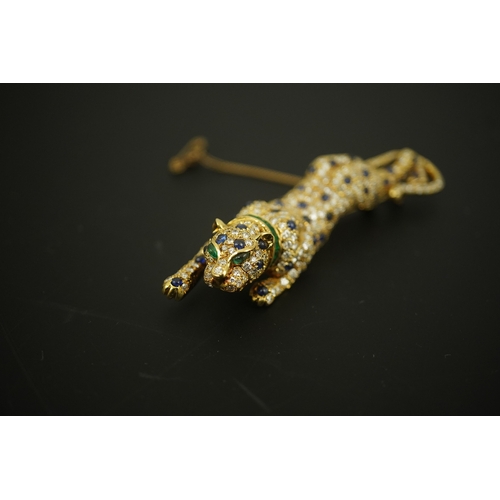 266 - A modern Cartier style 18k gold, sapphire, emerald and diamond cluster set stalking panther brooch, ... 