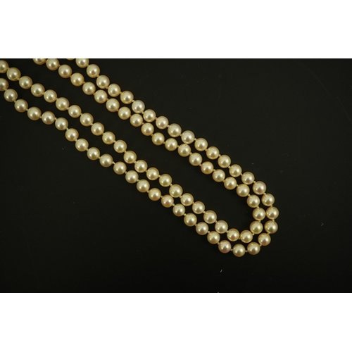 267 - A modern double strand cultured pearl necklace, with 18k gold and diamond set twin ring clasp, and t... 