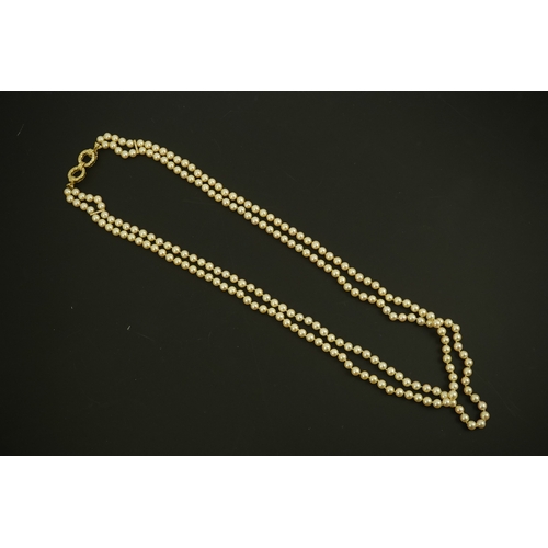 267 - A modern double strand cultured pearl necklace, with 18k gold and diamond set twin ring clasp, and t... 