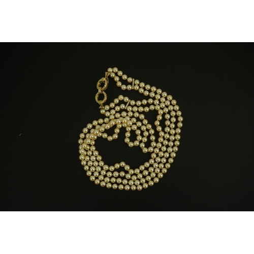 267 - A modern double strand cultured pearl necklace, with 18k gold and diamond set twin ring clasp, and t... 