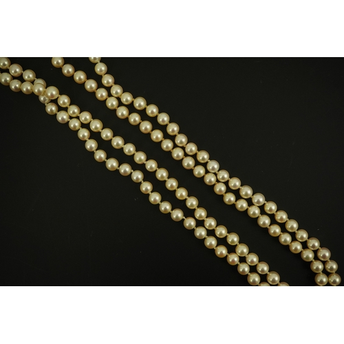 267 - A modern double strand cultured pearl necklace, with 18k gold and diamond set twin ring clasp, and t... 