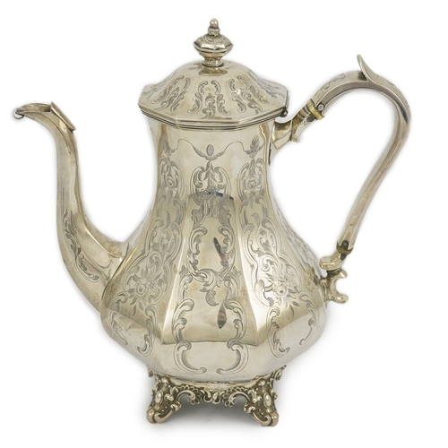 27 - A Victorian engraved silver coffee pot, by John Welby, of octagonal baluster form, on four scroll fe... 