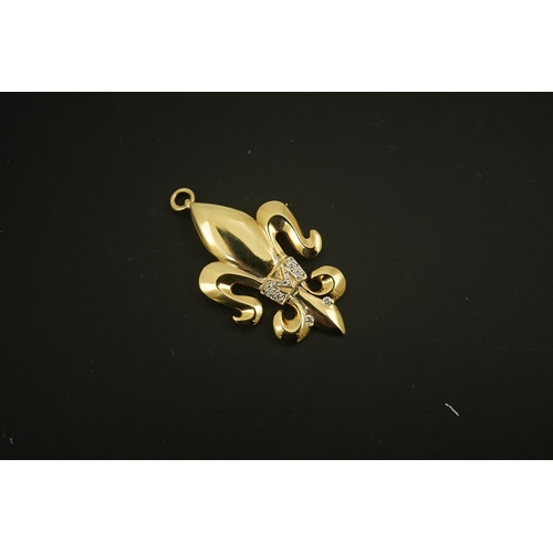 272 - A modern 14k gold and diamond chip cluster set fleur de lys pendant, 37mm, gross weight 5.3 grams, t... 