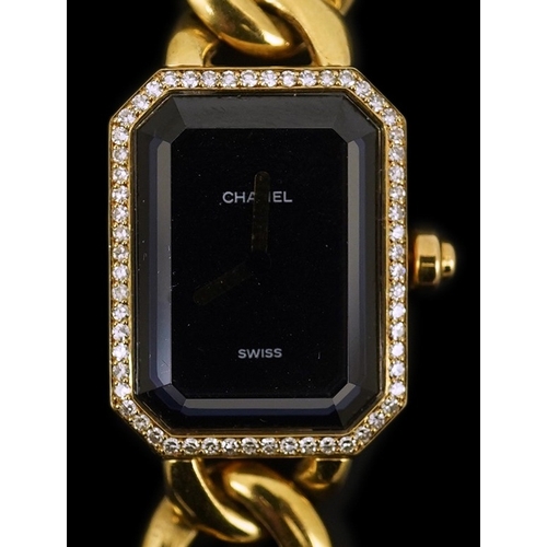 273 - A lady's modern 18ct gold and diamond set Chanel quartz wrist watch, on an 18ct gold Chanel oval lin... 