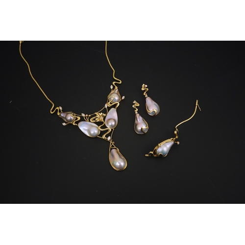 276 - A modern suite of 18k gold, baroque pear, round and marquise diamond set jewellery, comprising a nec... 