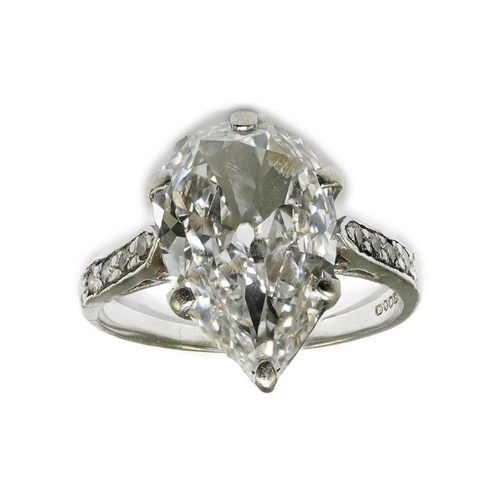 285 - A platinum and pear cut single stone diamond set ring, with diamond set shoulders, the stone weighin... 