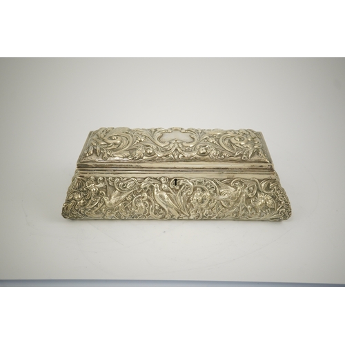 46 - An Edwardian repousse silver mounted jewellery casket, by William Comyns, of sarcophagus form and de... 