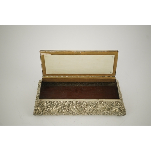 46 - An Edwardian repousse silver mounted jewellery casket, by William Comyns, of sarcophagus form and de... 