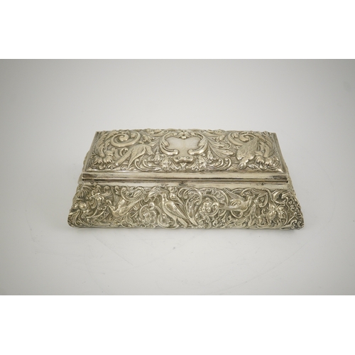 46 - An Edwardian repousse silver mounted jewellery casket, by William Comyns, of sarcophagus form and de... 