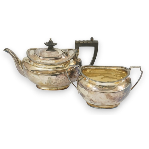 47 - An Edwardian silver teapot and a matching sugar bowl, with engraved inscription, relating to the Roy... 