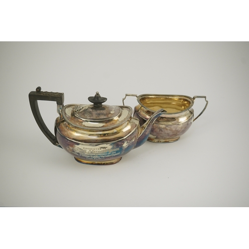 47 - An Edwardian silver teapot and a matching sugar bowl, with engraved inscription, relating to the Roy... 