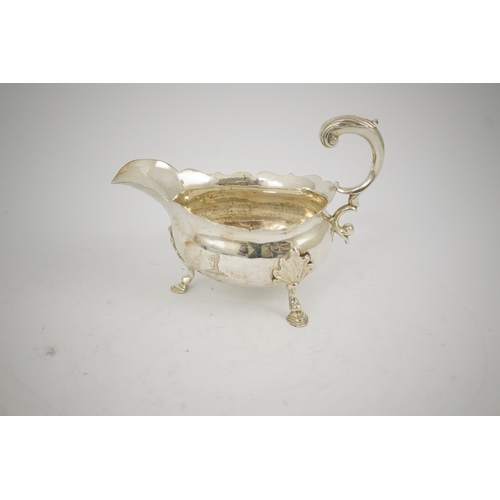 5 - A George II silver sauceboat, by William Shaw II & William Priest, with engraved armorials cut borde... 